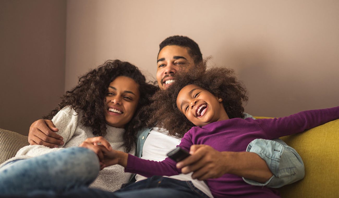 Family hugging on sofa