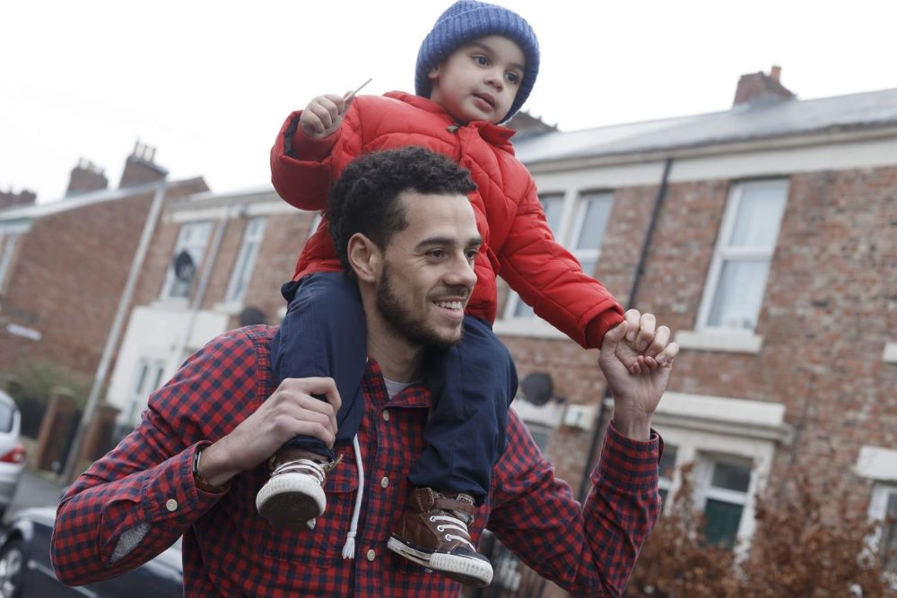 Child on fathers shoulders