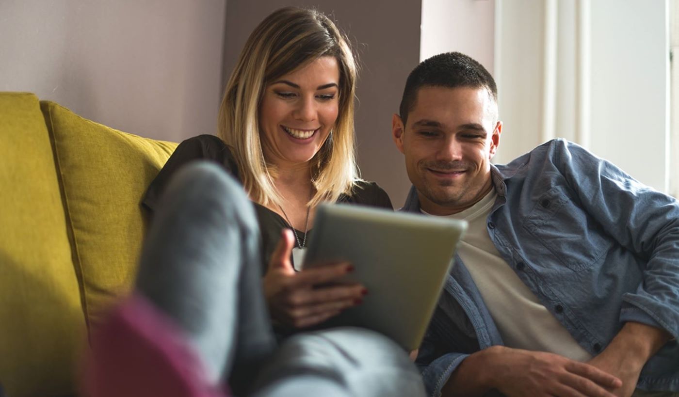 Customer couple looking at tablet