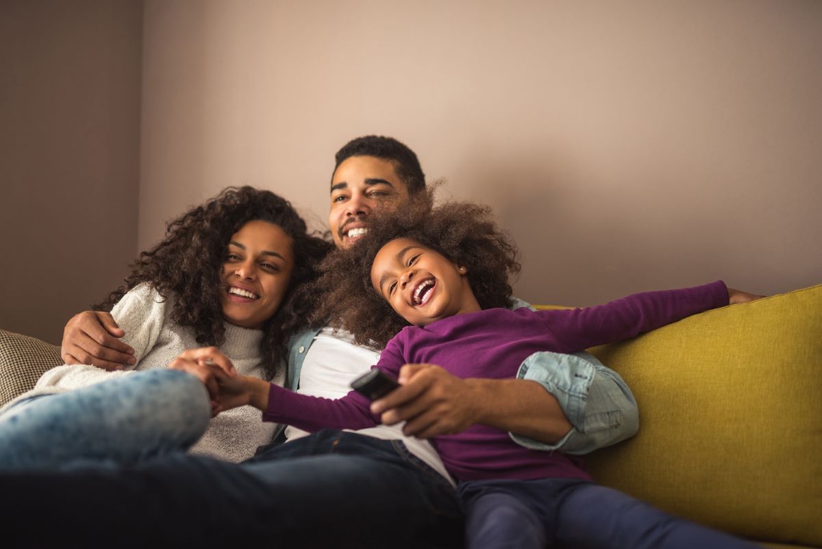 Family hugging on sofa