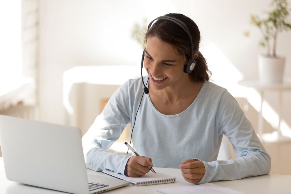 woman on laptop with headset