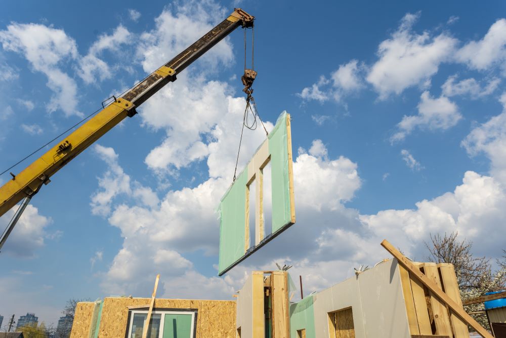 Crane lifting modular housing