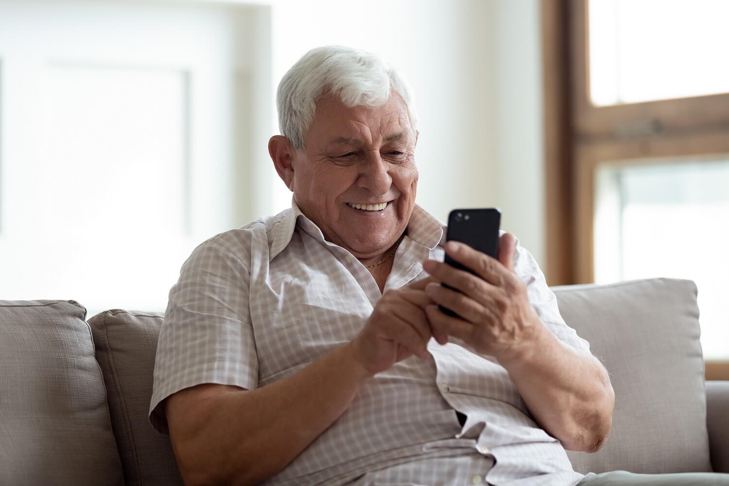 Elderly man looking at his phone