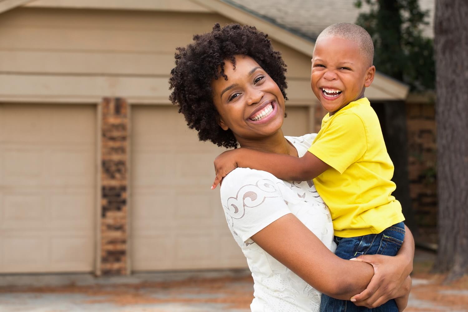 Mother holding child smiling