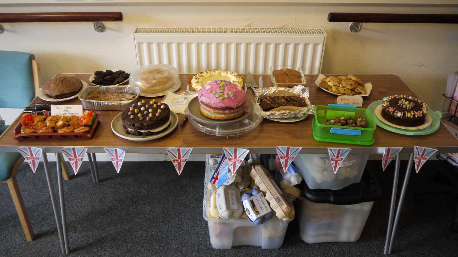 Photo of table with cakes, biscuits and other treats.
