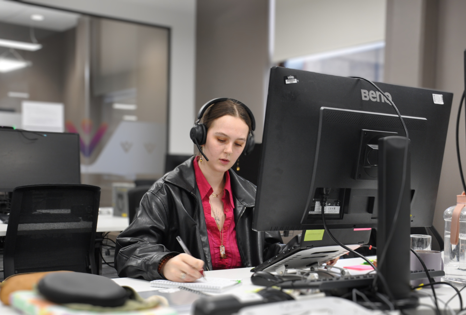 Member of staff on the phone taking notes