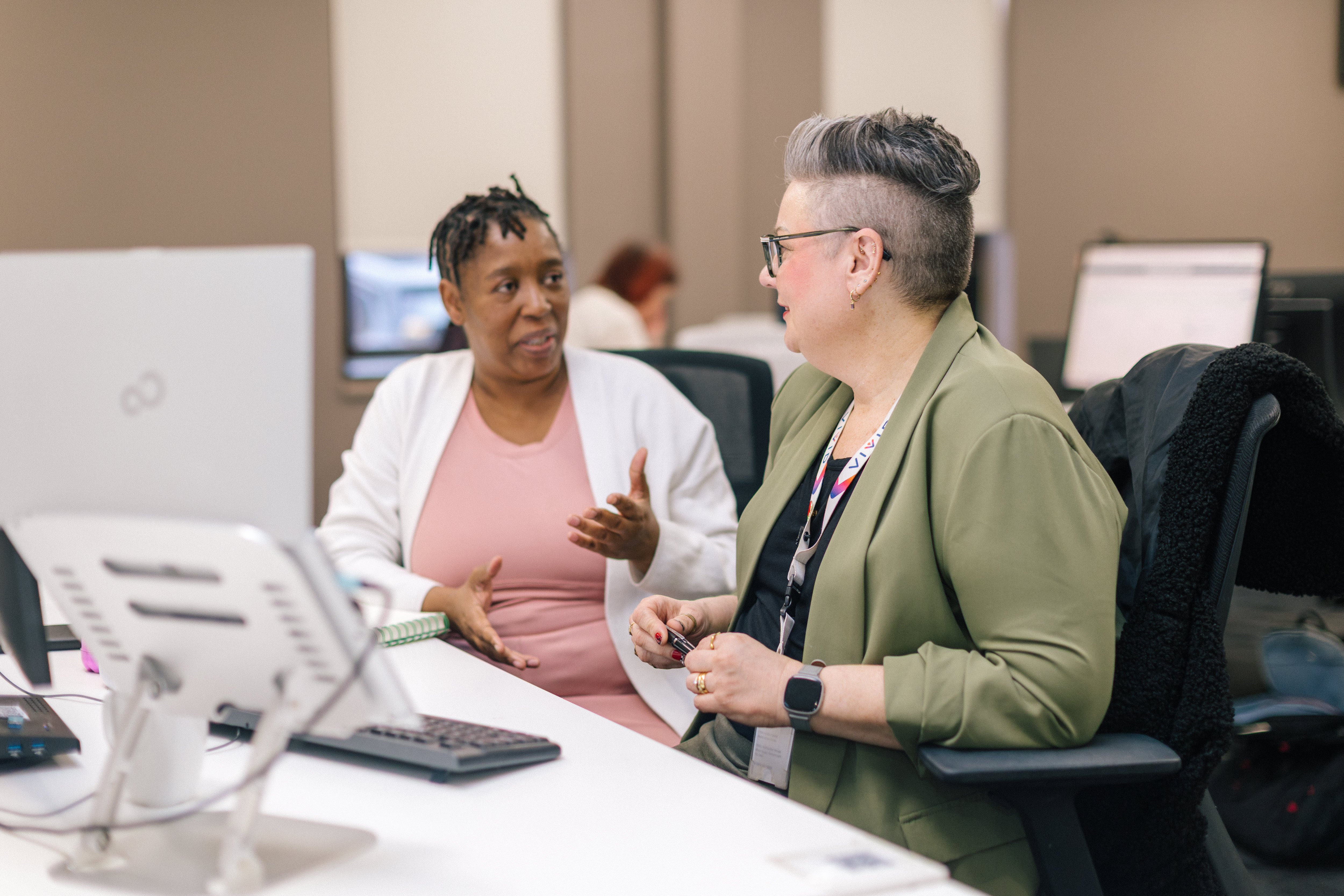 Staff members talking in office