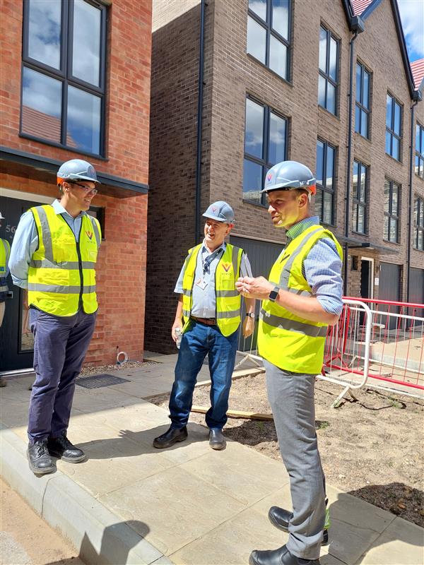 People wearing VIVID PPE talking at development site