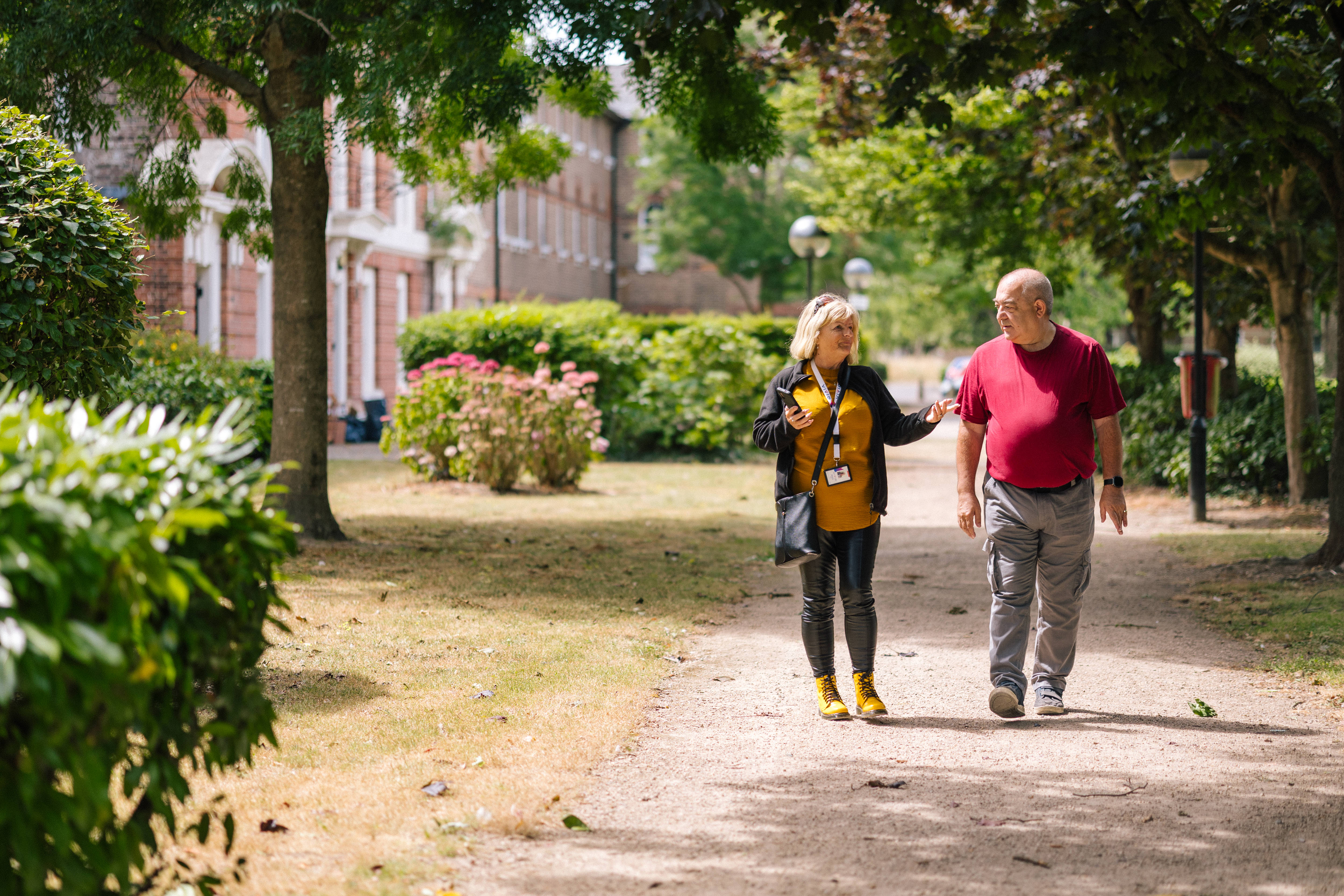 Member of staff and a customer walking together