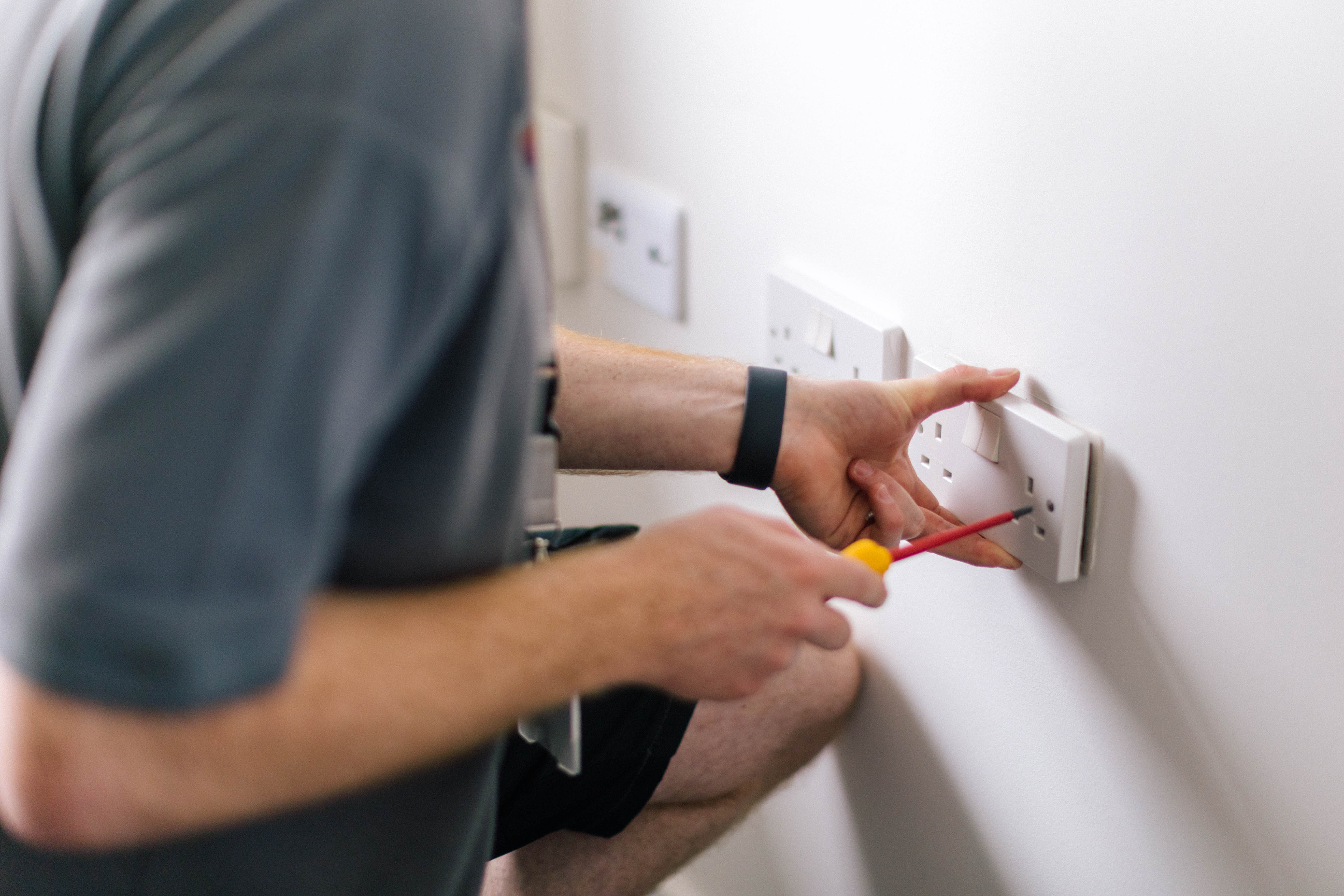 VIVID staff member fixing an electrical socket