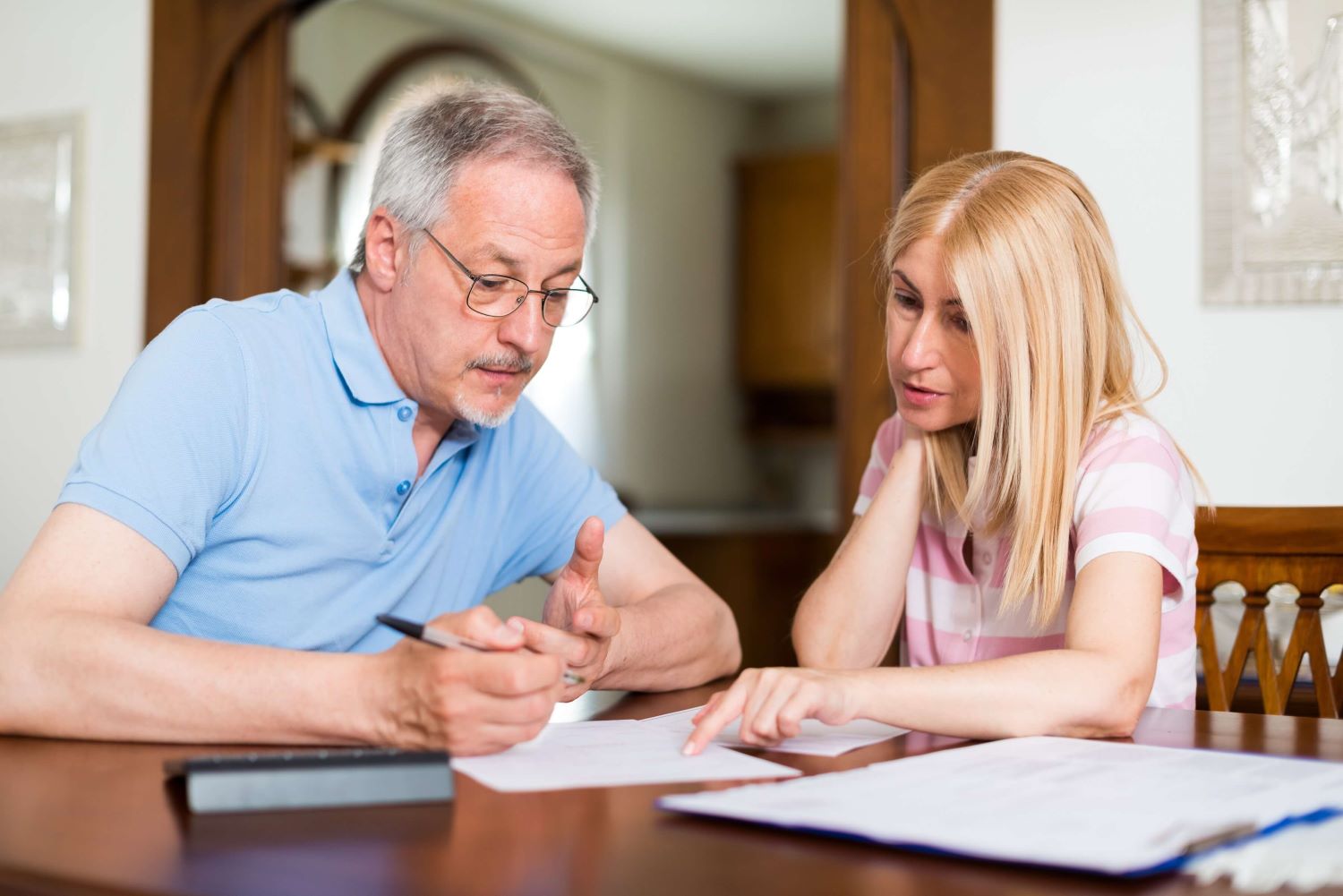 man and woman looking at forms